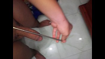 Vietnamese boys use chopsticks to poke holes in the flute