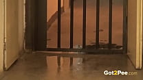 Pee Desperation - Hot brunette relieves herself outside in a doorway