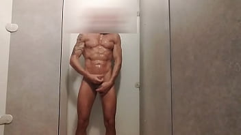 muscled guy jerks off in gym shower
